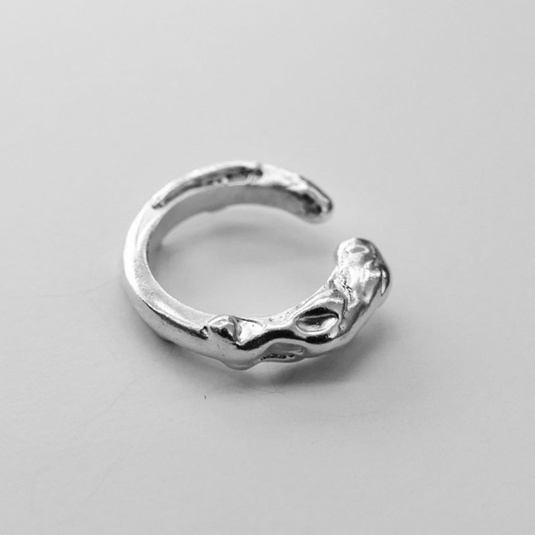 Fluid, abstract, handcrafted sustainble silver molten ring. Handmade jewellery brand Nowhere Soon Studio. London based designer.