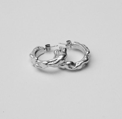 Sustainable recycled silver large abstract hoop earrings. Handcrafted in London. Unique modern jewellery by Nowhere Soon Studio.